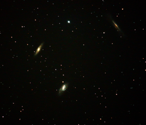 It's a small galaxy cluster in Leo that happens to be bright enough and close enough together to fit into one picture, even though each of them are about 35 million light years away.