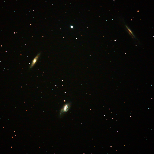 It's a small galaxy cluster in Leo that happens to be bright enough and close enough together to fit into one picture, even though each of them are about 35 million light years away.